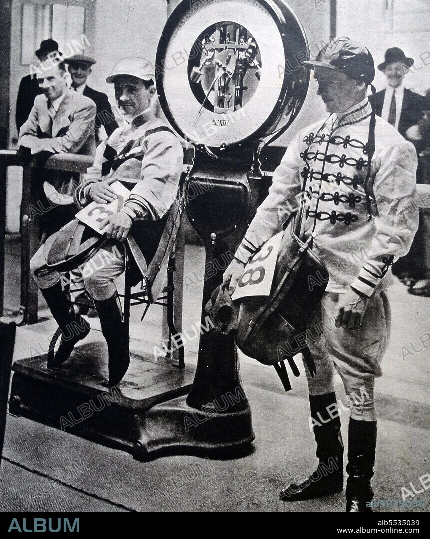 Flat jockey Gordon Richards weighs out for his next race while his brother Cliff Richards awaits his turn. Illustrated news cutting. Sir Gordon Richards (5 May 1904 - 10 November 1986) was an English jockey. He was the British flat racing Champion Jockey 26 times and is often considered the world's greatest jockey ever. He remains the only flat jockey to have been knighted.