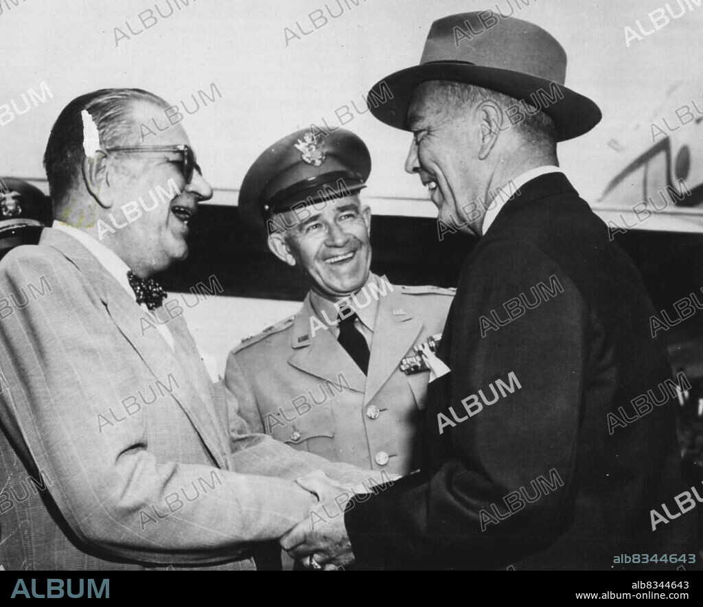 Radford Gets Hearty Welcome -- Admiral Arthur W. Radford (right) gets a hearty welcome from Admiral William Fechteler (left) and General Omar Bradley upon his arrival here yesterday to become chairman of the joint chiefs of staff. Bradley is giving up that job. Fechteler is retiring as chief of naval operations. Following Navy custom in Sunday off-duty attire, the two Admirals are in civilian clothes. Radford flew here form Honolulu where he has been commander in chief in the Pacific. July 13, 1953. (Photo by AP Wirephoto).