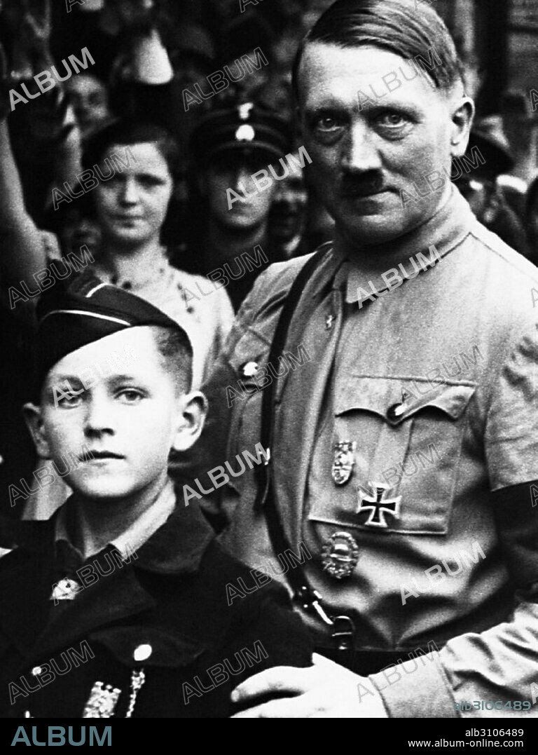 Adolf Hitler 1889-1945, German Nazi leader, seen standing with a young Hitler Youth Member 1934.