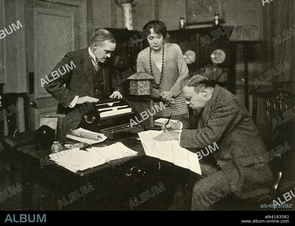 'Hornblower surrenders', 1920, (1928). 'Mr. George Elton as Dawker; Miss Helen Heye as Mrs. Hillcrist and Mr. Edmund Gwenn as Hornblower, in "The Skin Game"'. Scene from "The Skin Game" play by British playwright John Galsworthy (1867-1933). It was first performed in 1920 at the St Martin's Theatre, London. From "The Bookman - Special Christmas Number 1928". [Hodder & Stoughton Ltd, London, 1928].
