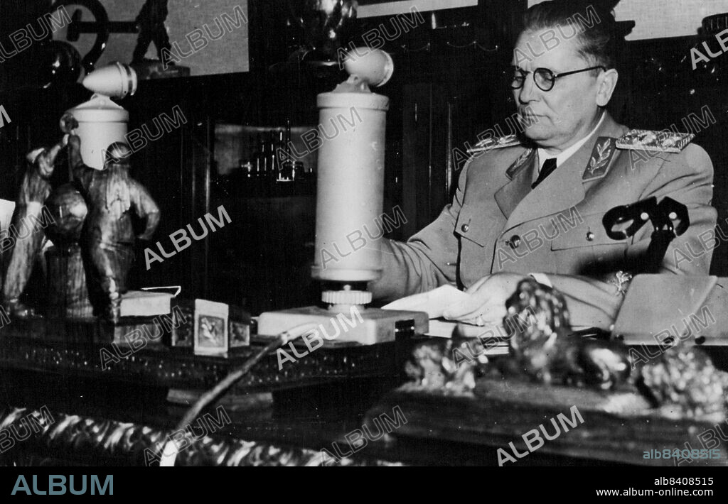 Marshal Tito Broadcasts -- This latest picture of Josip Broz (Marshal Tito) shows him addressing a radio audience from his study in Belgrade over the Yugoslav network. January 12, 1948. (Photo by Associated Press Photo).