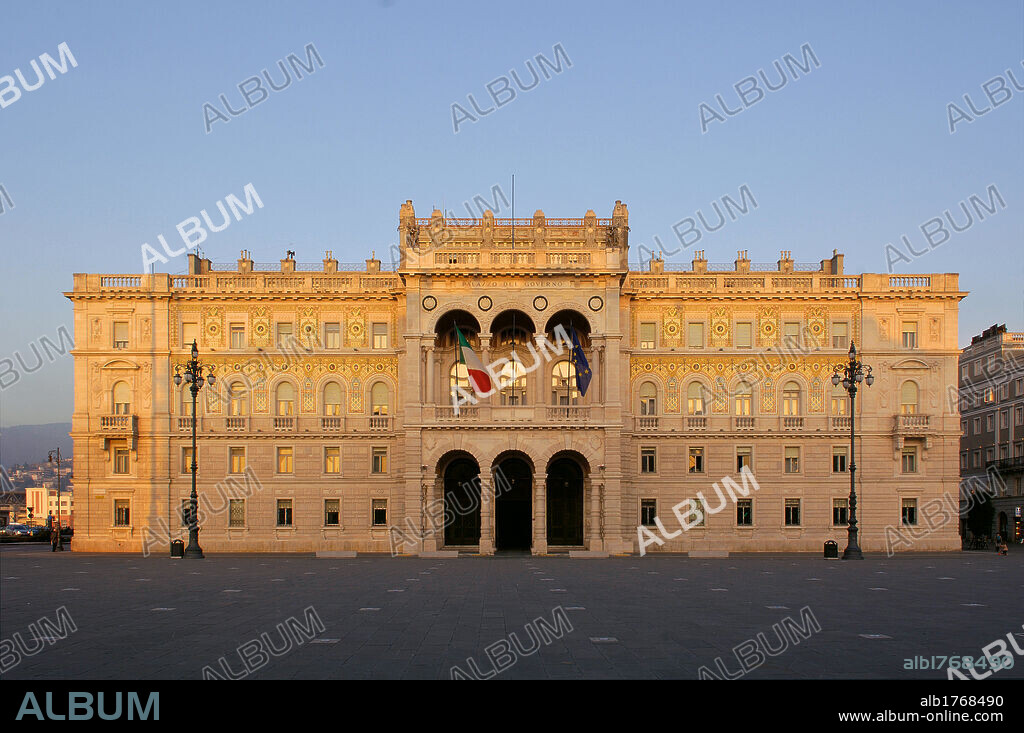 Palazzo della Prefettura di Trieste (Palazzo del Governo), by Unknown Artist, 1904-1905, 20th Century,. Italy, Friuli Venezia Giulia, Trieste, Piazza Unit dItalia, Palazzo della Prefettura (Palazzo del Governo). All. Exterior axial view front facade Palazzo del Governo Prefecture Istria Istrian white stone main body projecting jutting portico porch arcades rustic columns loggia coping crown side wings ashlar work rustication windows lining cladding Murano glass mosaics street lamps lamp posts Piazza Unit dItalia.  Please remember that author's rights have to be cleared for modern and contemporary works of arts.