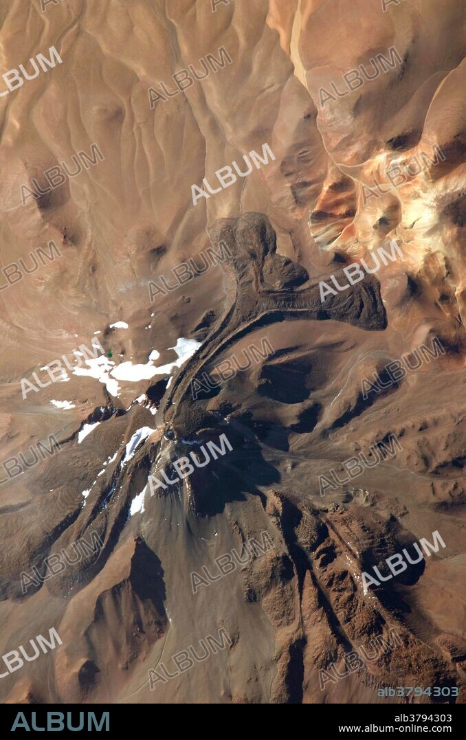 View from space of Llullaillaco Volcano, located on the Argentina-Chile border. At an elevation of 22,110 feet, it is the highest historically active volcano in the world. The last eruption was in 1877.