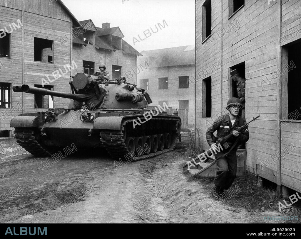 A tank and infantry of the US army during an exercise on the 11th of October in 1962 in the ghost village "Parks Range" in Berlin-Lichterfelde, which was especially built for army training. 11/10/1962