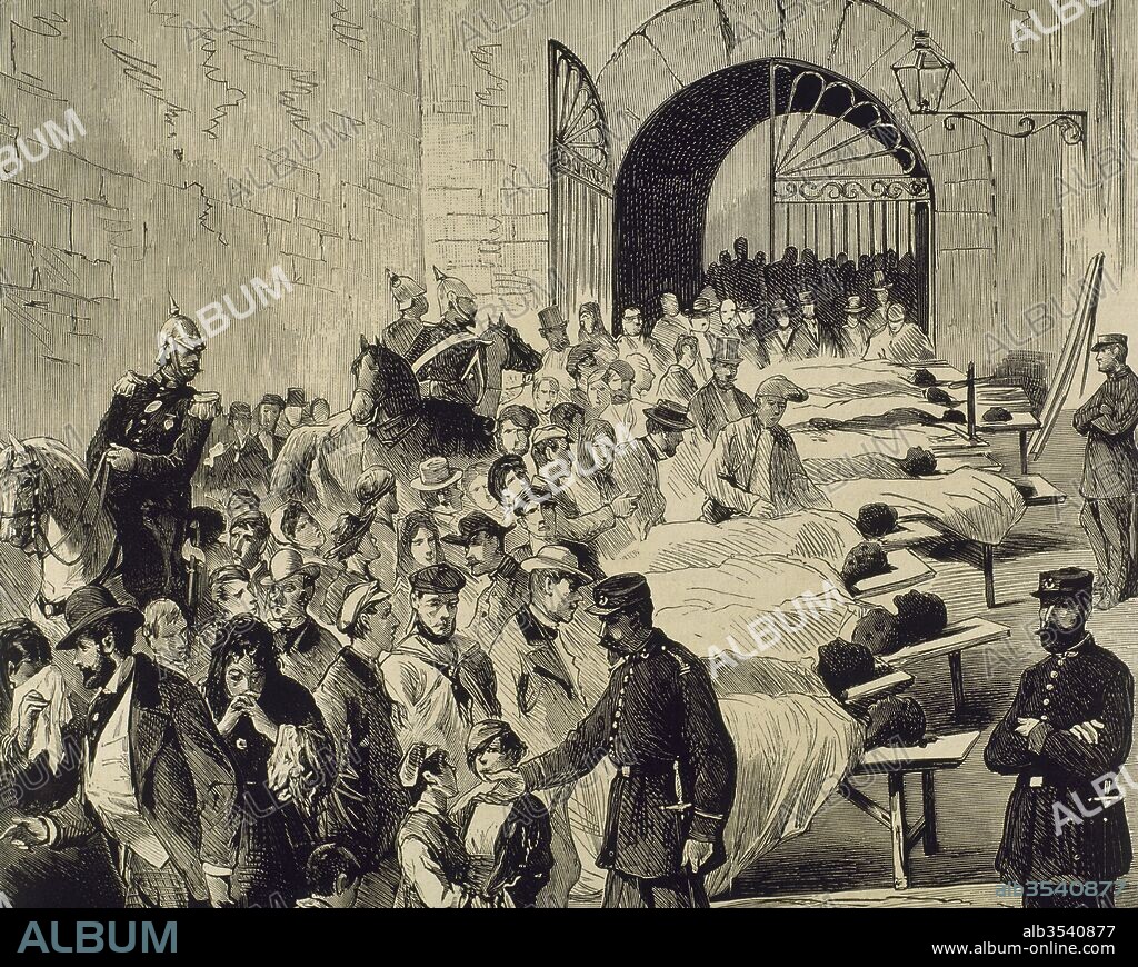 Exhibición de las víctimas de la explosión del vapor "Express", para identficar a las personas, en el patio del hospital. El suceso ocurrió en el puerto de Barcelona el día 17 de agosto de 1875, a causa del incendio en las municiones que se cargaban con destino al sitio de la Seo. Fué uno de los primeros vapores de la matrícula de Barcelona. Cataluña. Dibujo por Enrique Serra, grabado por Rico. La Ilustración Española y Americana, 8 de septiembre de 1875.