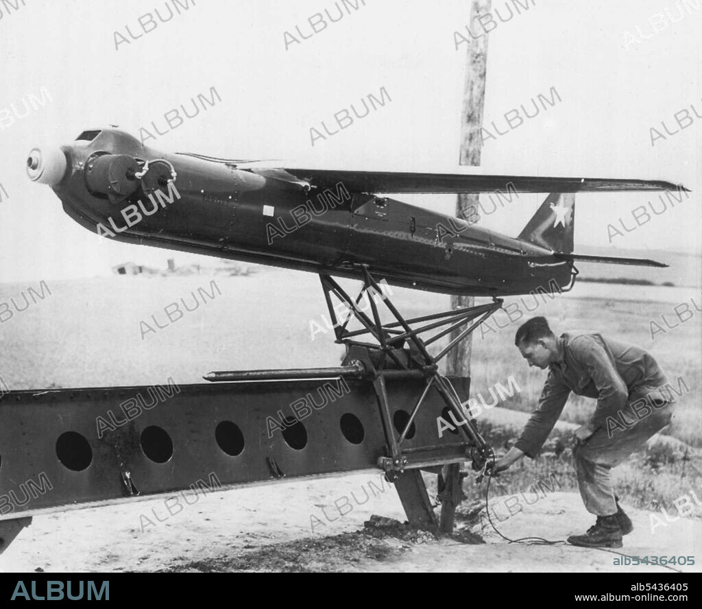 Target For Track-and-Destroy Anti-Aircraft Gun -- An "R-Cat" 300-mile-per-hour, radio-controlled target airplane is prepared for take-off at demonstration at Weybourne, England, during test of new U.S. 75mm skysweeper Anti-Aircraft gun. The new gun, demonstrated for senior British officers and reporters by the 32nd Anti-Aircraft Artillery Bridge, has built-in radar and an electronic brain that works cut speeds, heights and angles. It can fire 22 12-pounder shells in 30 seconds at aircraft flying.