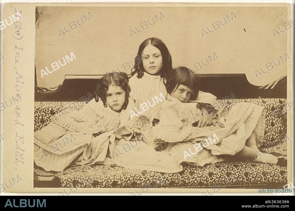 LEWIS CARROLL (ECRIVAIN). Edith, Ina and Alice Liddell on a Sofa. Artist: Lewis Carroll (British, Daresbury, Cheshire 1832-1898 Guildford). Dimensions: Mount: 4 3/16 in. × 6 7/16 in. (10.7 × 16.3 cm)
Image: 4 1/16 × 6 1/16 in. (10.3 × 15.4 cm). Person in Photograph: Person in photograph Alice Pleasance Liddell (British, 1852-1934); Person in photograph Edith Mary Liddell (British, 1854-1876); Person in photograph Ina Liddell (British, 1849-1930). Date: Summer 1858.