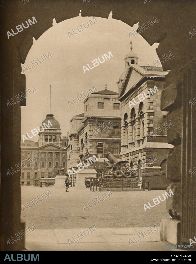 'Horse Guards Parade Framed in the Archway of Treasury Passage', c1935. Military parade ground off Whitehall in Westminster, London. It is the site of the annual ceremonies of Trooping the Colour on the monarch's official birthday, and Beating Retreat. Just right of centre is the Cadiz Memorial, a French mortar in the style of a Chinese dragon, which was captured at the battle of Salamanca. It was presented to Britain by Spain to mark the lifting of the siege of Cádiz in 1812 by the Duke of Wellington. From "Wonderful London, Volume 1", edited by Arthur St John Adcock. [The Fleetway House, London, c1935].