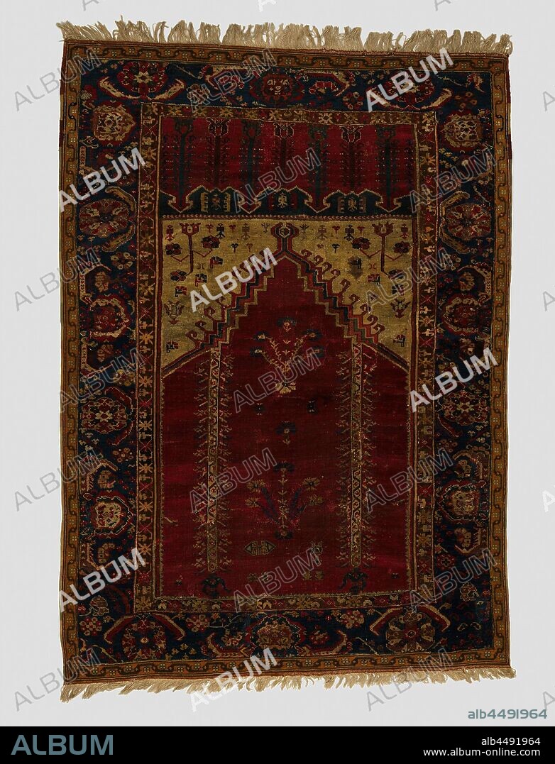 Oriental carpet, Ghiordes prayer rug. In the midfield a cerisode mihrab with carnations. Triple edge, the main edge of which is in cornflower blue with rosette flowers. Button: Ghiordes button., Roemenie (possibly), 1600 - 1725, ketting en inslag, h 150 cm × w 100 cm.