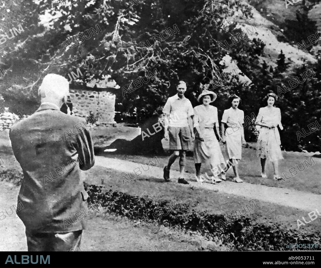 Photograph of King George VI with his wife and two daughters, Princess Margaret (right) and Princess Elizabeth (left) whilst Jan Smuts takes a Cine Record in South Africa. George VI (1895-1952) King of the United Kingdom and the Dominions of the British Commonwealth, the last Emperor of India and the first Head of the Commonwealth. Queen Elizabeth The Queen Mother (1900-2002). Princess Margaret, Countess of Snowdon (1930-2002). Princess Elizabeth (1926-) Queen of the United Kingdom, Canada, Australia and New Zealand. Field Marshall Jan Christiaan Smuts (1870-1950) a prominent South African and British Commonwealth statesman, military leader and philosopher. Dated 20th Century.