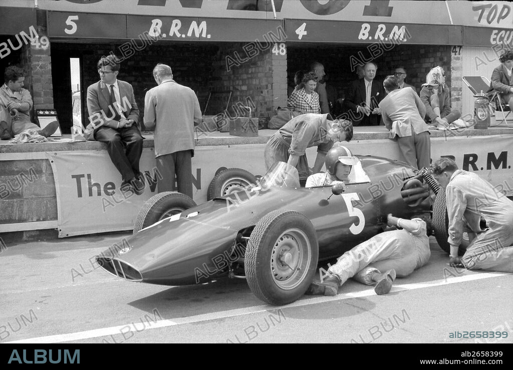 Tony Rudd and Peter Berthon, with Dan Gurney in his BRM P48 in the pits at the British GP, Silverstone, England 1960.