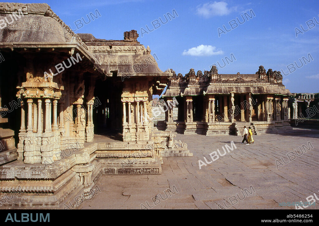 The Vittala Temple, built in the early 16th century, is devoted to the Hindu god Vithoba (also known as Vitthala and Panduranga), an incarnation of Vishnu or his avatar Krishna. Hampi is a village in northern Karnataka state. It is located within the ruins of Vijayanagara, the former capital of the Vijayanagara Empire. Predating the city of Vijayanagara, it continues to be an important religious centre, housing the Virupaksha Temple, as well as several other monuments belonging to the old city.