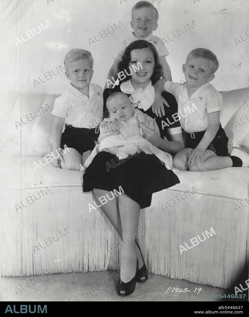Why Bing Croons -- Five reasons why Bing Crosby Sings so much are in this photograph of this wife, beautiful Dixie Lee, and their four children. Left to right, the older boys are Phillip and Dennis, the twins, and Gary. Baby Lindsay is sitting on this Mother's Lap. Gary made his screen debut as an extra in a mob scene in Paramount's "sing You Sinners" Star ***** in which his father stars. January 13, 1940.