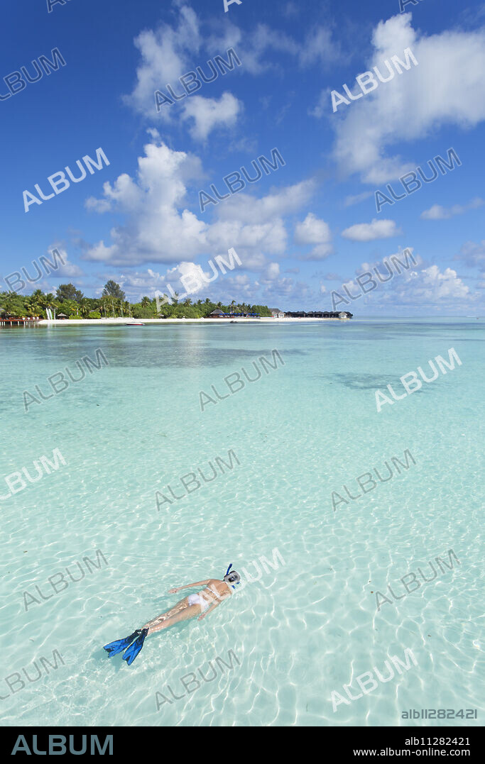 Woman snorkelling at Olhuveli Beach and Spa Resort, South Male Atoll, Kaafu Atoll, Maldives, Indian Ocean, Asia.