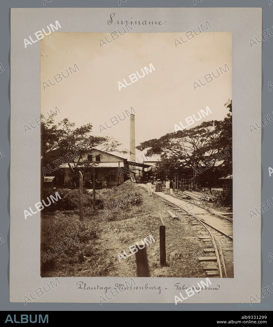 Plantation Marienburg - Factory Building (title on object), View of the factory building for processing sugar cane on Plantation Marienburg. With several people standing near a railroad track. Part of a group of 44 photographs of Paramaribo, Suriname and Curaçao, c. 1900-1905, mounted on cardboard and inscribed., Eugen Klein (attributed to), Suriname, 1900 - 1905, photographic support, cardboard, height 223 mm × width 175 mm.