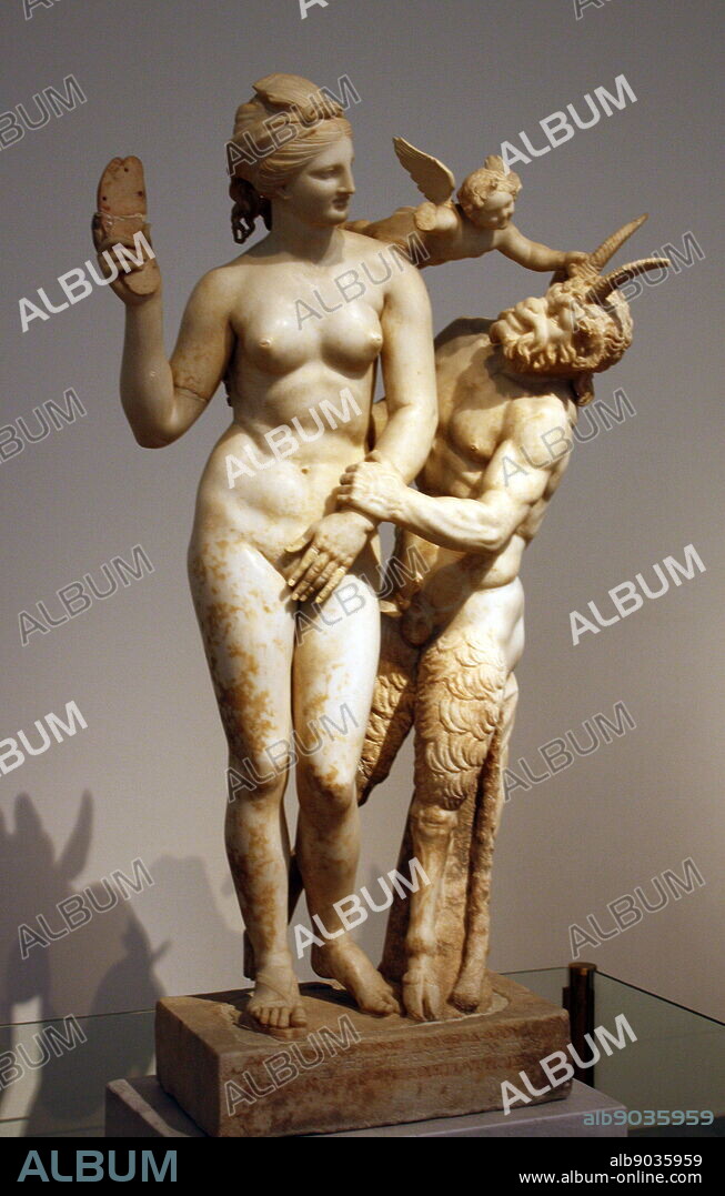 Group of Aphrodite, Pan and Eros. Paian marble. Found in the 'House of the Poseidoniastai of Beryttos' (Beirut), Delos. Traces of colour can be made out in many places. The nude goddess Aphrodite attempts to fend off the goat-footed god Pan. She holds her sandal threateningly in her right hand, while the winged god Eros comes to her aid. About 100 BC.