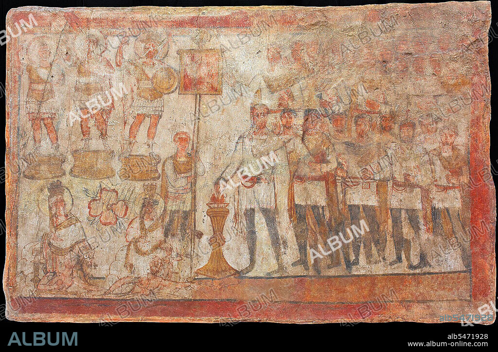 Fresco from the Temple of the Palmyran Gods in Dura Europos (c. 230 CE): An officer named Julius Terentius leads the soldiers of the 20th Palmyrenes, a cohort of mounted archers stationed on the Euphrates, in a ritual of bloodless sacrifice. He burns incense in honour of the three cult statues of gods dressed in military costume (Yarhibol, Aglibol, and Arsu), ranged on their pedestals on the upper left side of the fresco. Beside Terentius is the standard bearer of the cohort with the troop colours and, next to him, a seated goddess who wears the mural (city) crown: an inscription identifies her as the goddess of Good Fortune of Palmyra.