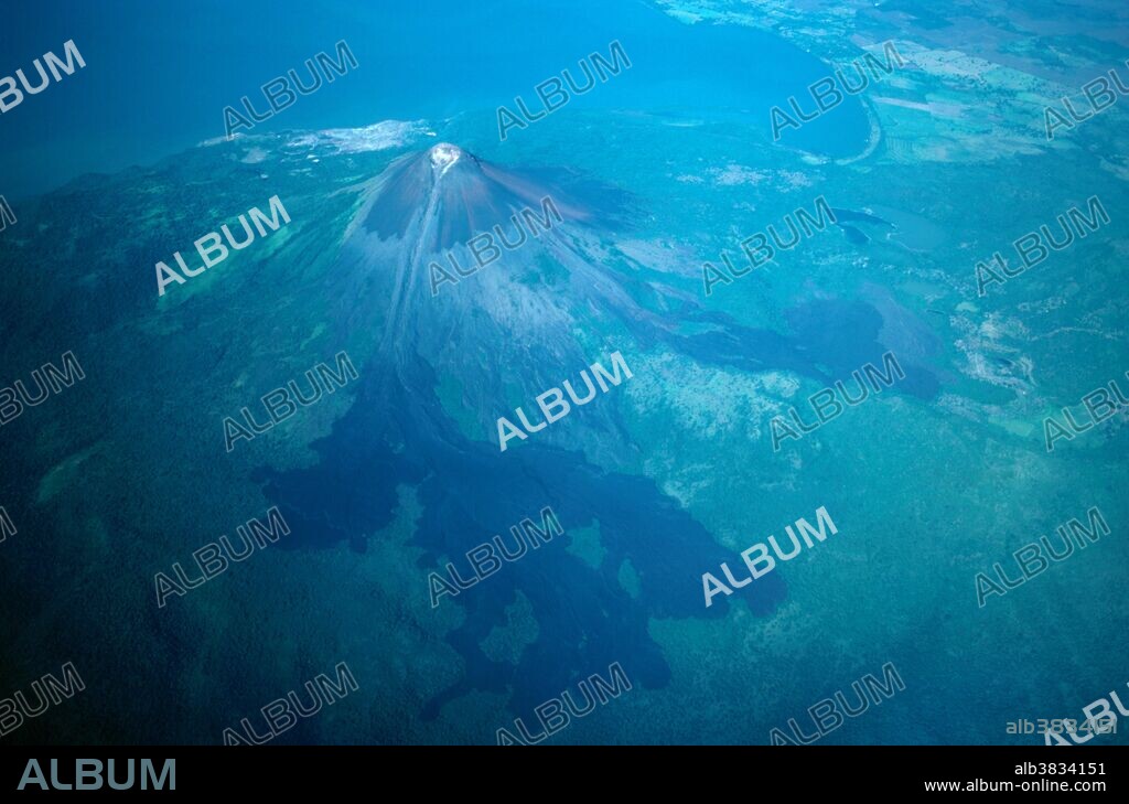 Volcano Momotombo, an active volcano on Lake Managua, Nicaragua. Notice the thermal energy plant visible on the lakeshore.