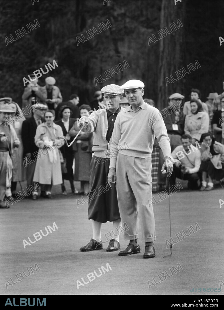 Pebble Beach, California: c. 1948. Bing Crosby and Ben Hogan discuss golf.