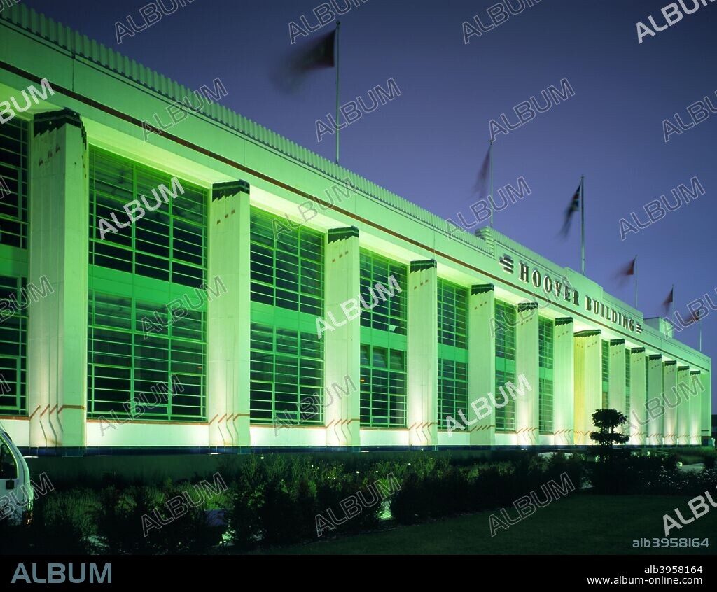 The Hoover Building, Western Avenue, Perivale, London, c2000s(?). Exterior view at night. The facade of this 'bypass factory', located on the busy Western Avenue approach to London, was designed to 'flash upon the eye of the passing motorist'. The clean lines of the 1930s art deco exterior advertised the modern, hygienic appliances produced inside. The building was designed by Wallis, Gilbert and Partners.