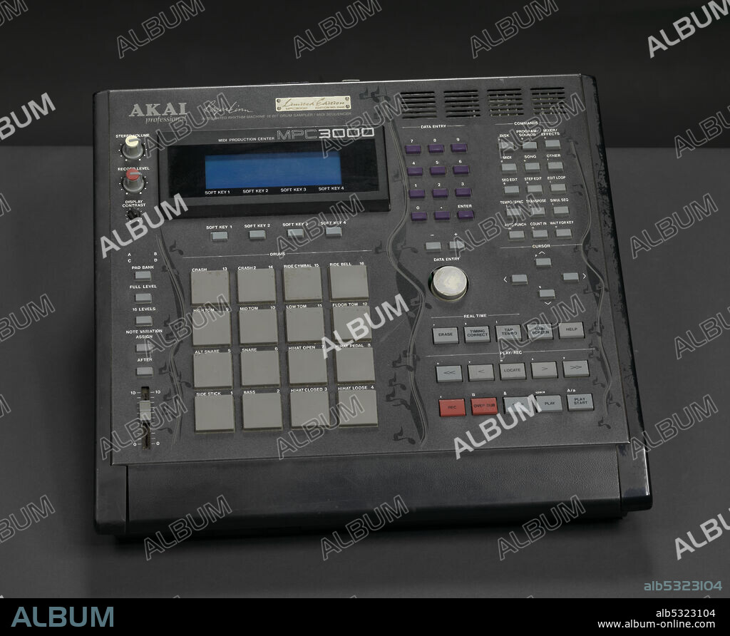 AKAI PROFESSIONAL. An AKAI MPC 3000 Limited Edition integrated rhythm machine, drum sampler, and midi sequencer used by record producer and artist J Dilla. The machine consists of a black plastic box with a small screen in the upper left corner, multiple key pads, and a vertical design of black musical notes along the left, center and right of the box. Grey type at the top of the machine reads, [AKAI/professional/Roger Linn/INTEGRATED RHYTHM MACHINE 16 BIT DRUM SAMPLER/MIDI SEQUENCER]. Gold plaque above the type reads, [Limited Edition/MPC3000/EDITION NO. 0449].
