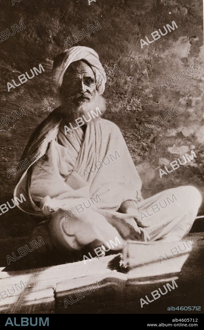 Sudan, Printed caption reads: 'Osman Digna, A Noted Leader in the Khalifa's Army. Published by G N Morhig, The English Pharmacy, Khartoum. Copyright 243'. Portrait of Osman Digna, sitting cross-legged on a mat, wearing a robe and turban. Digna was a general in the Mahdist army of Sudan from 1883 until his arrest by the British in 1900, [c.1906]. 2003/222/1/1/91.