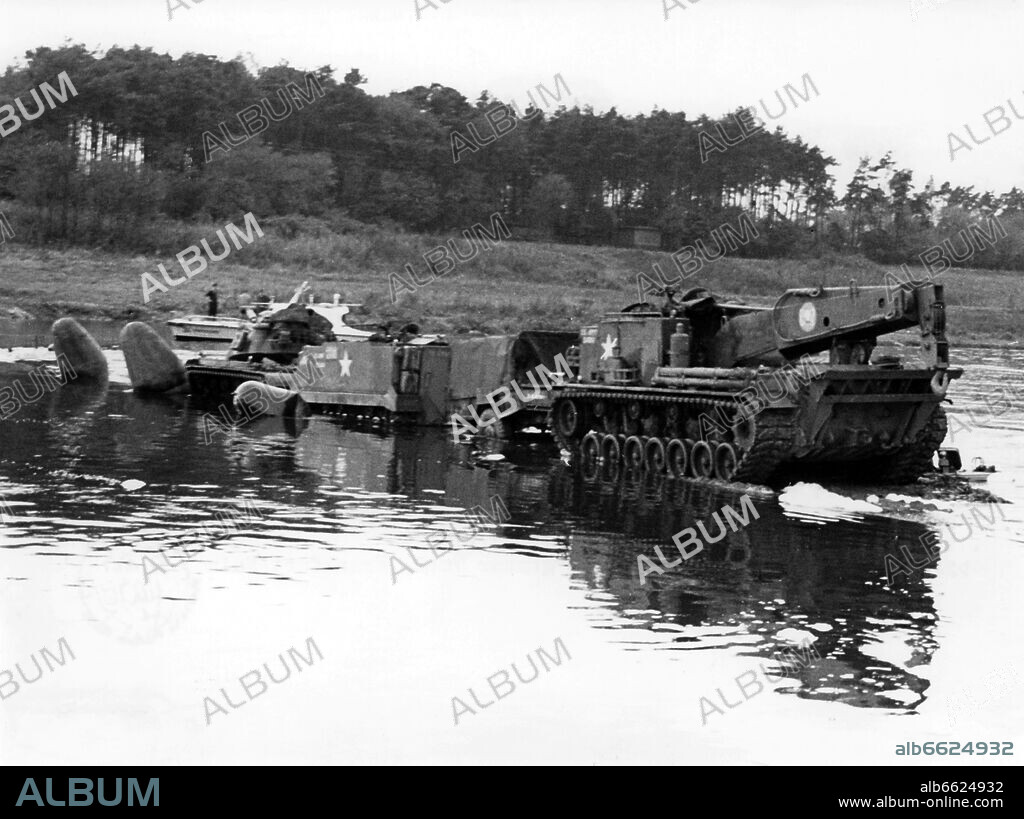 Soldiers of the US army try to recover a ferry which has sunk in the river Main near Klein-Ostheim in Hesse on the 9th of November in 1961.
The ferry, loaded with two heavy tanks and an armoured personnel carrier, had sunk during heavy rainfall. A soldier of the ferry crew drowned. 09/11/1961