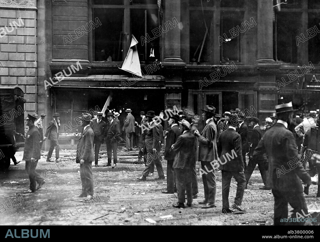Entitled: "Crowd gathered after the Wall Street explosion in front of the offices of J.P. Morgan." On September 16, 1920, a horse drawn wagon stopped across the street from the headquarters of the J.P. Morgan bank at 23 Wall Street. Inside the wagon, 100 lbs of dynamite with 500 lbs of cast-iron sash weights exploded in a timer-set detonation. The horse and wagon were blasted into small fragments, but the driver was believed to have left the vehicle and escaped. The 38 victims, most of whom died within moments of the blast, were mostly young people who worked as messengers, stenographers, clerks, and brokers. The bomb caused more than $2 million in property damage ($23,500,000 with inflation) and destroyed most of the interior spaces of the Morgan building. There were 143 seriously injured, and the total number of injured was in the hundreds. The bombing was never solved, although investigators and historians believe the Wall Street bombing was carried out by Italian anarchists, a group responsible for a series of bombings the previous year. Photographed by Underwood & Underwood, 1920.