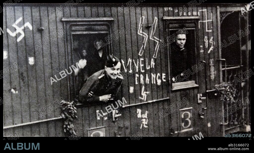 French volunteers to the Waffen SS are shown departing on a train towards their garrison (Fort/camp). The train is heavily graffitied with Nazi propaganda, including swastikas and SS logos. Dated 1940.