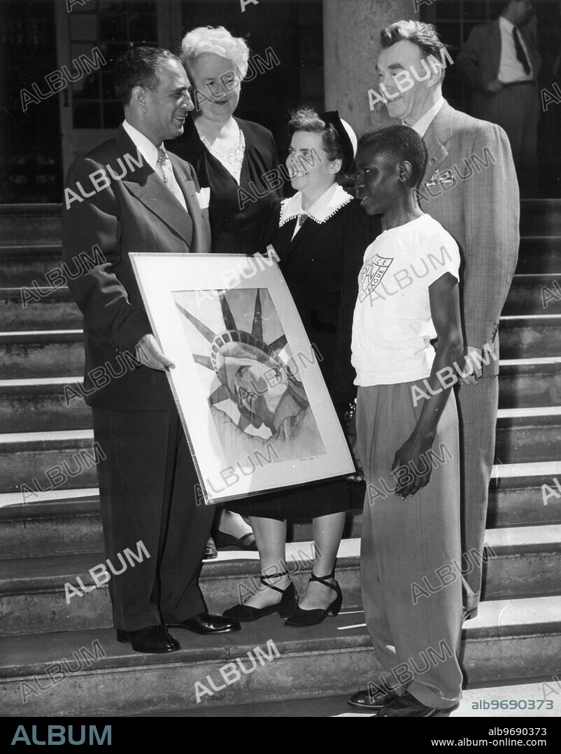 Mayor Vincent R. Impellitteri presents to M. Charlette Guedenet, assistant to cultural counsellor or French embassy, the grand prize winner of the Washington Square outdoor art show's Statue of Liberty contest. Drawings were submitted by children of PAL, boy and girl scouts. Looking on during ceremonies are Nell Boardman, chairman of Washington Square art show, Deputy police Commissioner Jas P. Nolan of PAL and Samuel Reed, the young artist who submitted the winning drawing.