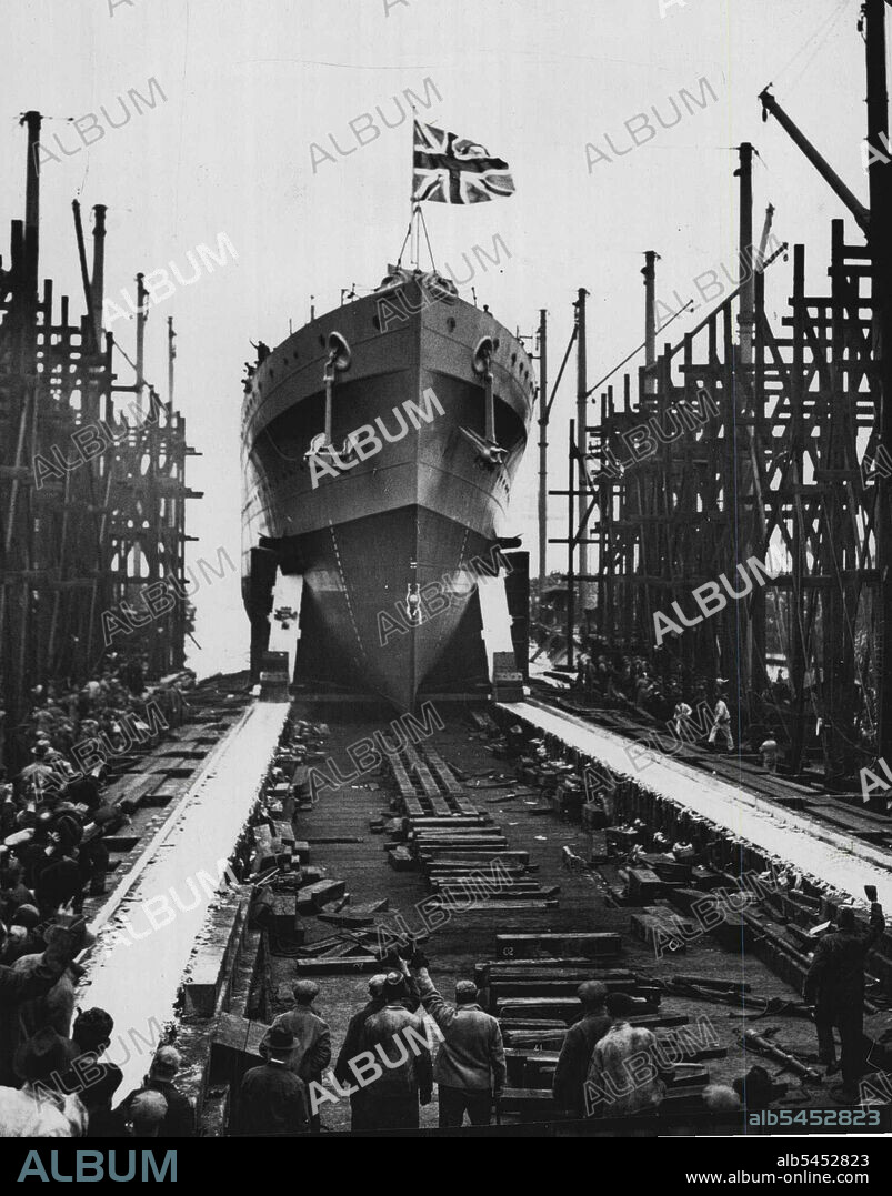 New British Cruiser Launched -- The new 6,000-ton cruiser, H.M.S. "Neptune" was launched at Portsmouth dockyard on Jan. 31st. By Mrs. Euan Wallace, wife of Capt. T.D. Euan Wallace, M.C., Civil lord of the admiralty.H.M.S. "Neptuen" taking the water. March 13, 1933. (Photo by Sport & General Press Agency, Limited).