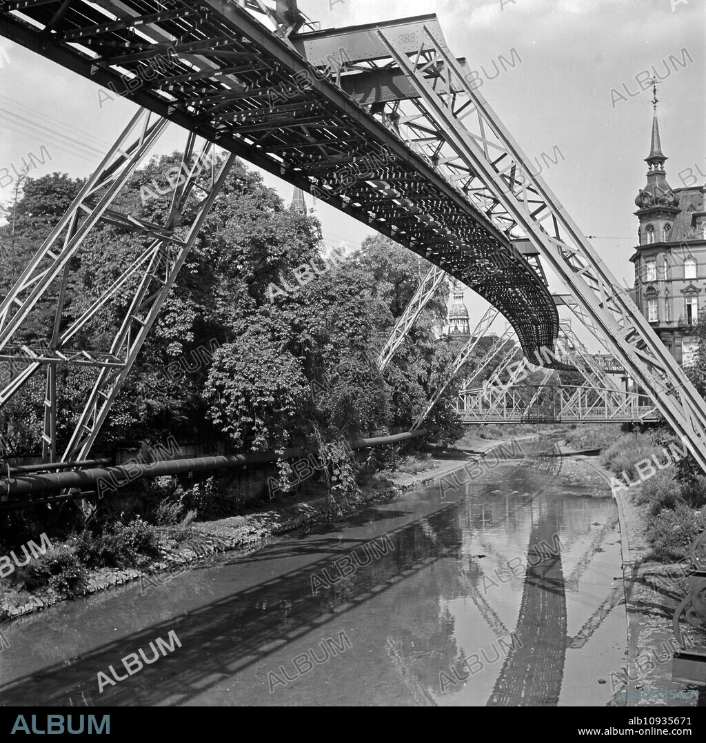 Wuppertal Suspension Railway refelcting in the river Wupper, Germany 1930s.