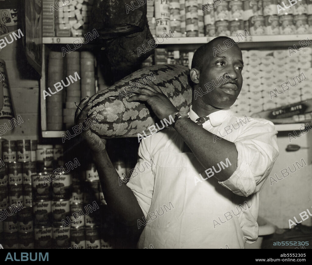 GORDON PARKS. Washington, D.C. Mr. J. Benjamin, owner of the grocery store patronized by Mrs. Ella Watson, a government charwoman.