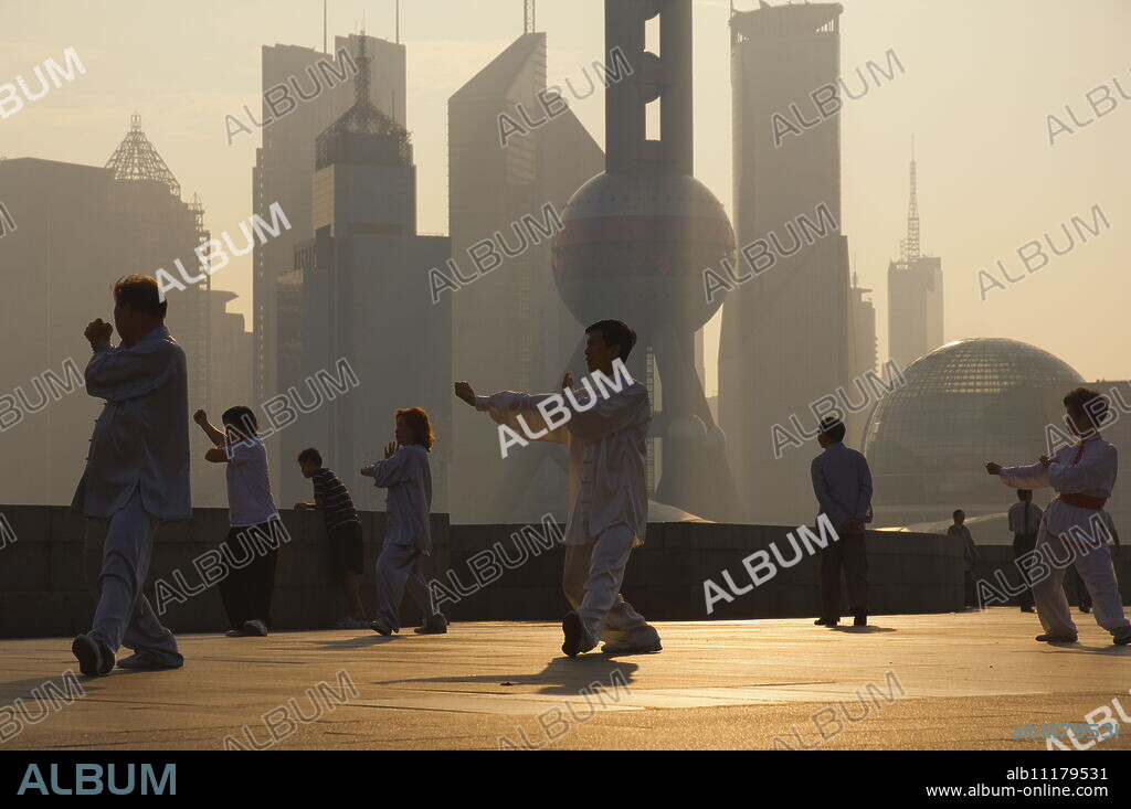 Morning exercise against the background of Lujiazui Finance and trade zone, with Oriental Pearl Tower, Shanghai, China, Asia.
