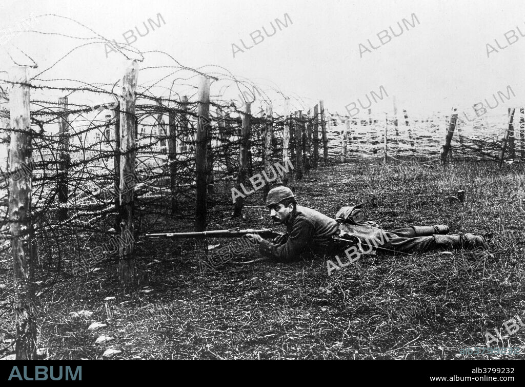 German sniper laying on ground near barbed wire defenses. Throughout World War I, snipers were often used in the trenches in an effort to take out enemy soldiers as their heads peered over the top of the opposing trench. At the start of WW I, only Germany issued scoped rifles to their troops. The effectiveness of the German snipers resulted in their reputation which was due in part to their training, but also due to the high-quality lenses manufactured by the Germans, as the deadliest and most efficient sharp shooters during the war.