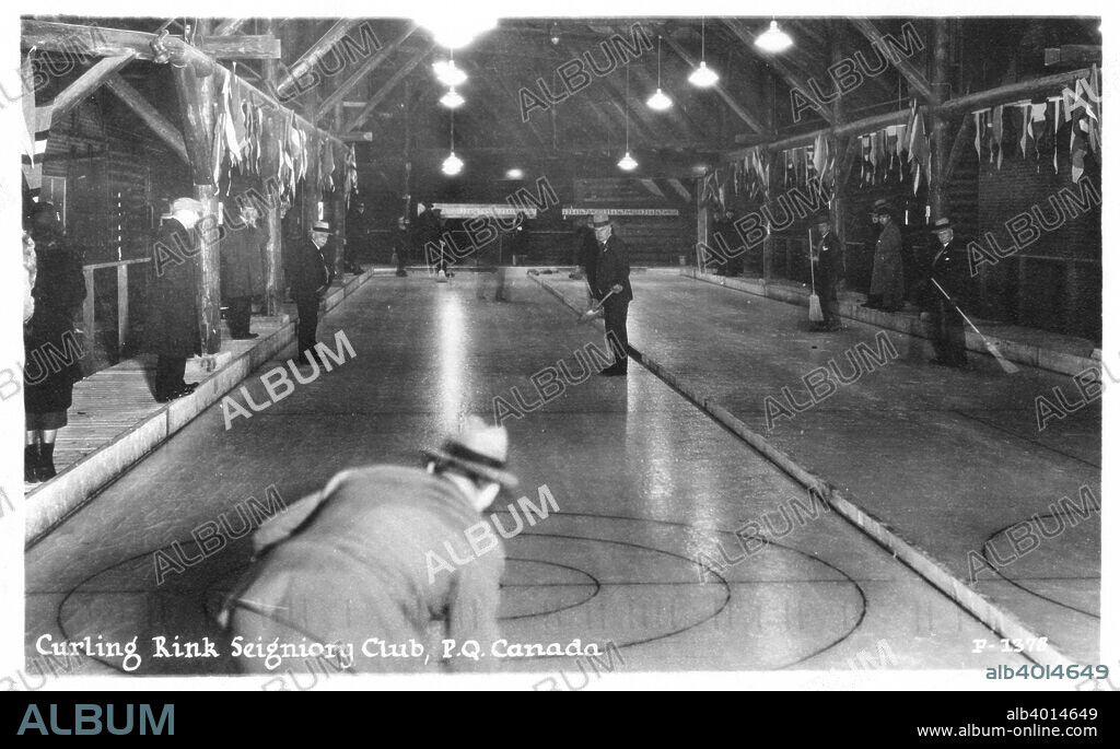 Curling rink Seigniory Club, Montebello, Quebec, Canada. View of the interior of a curling rink where men are playing the sport and spectators are observing.