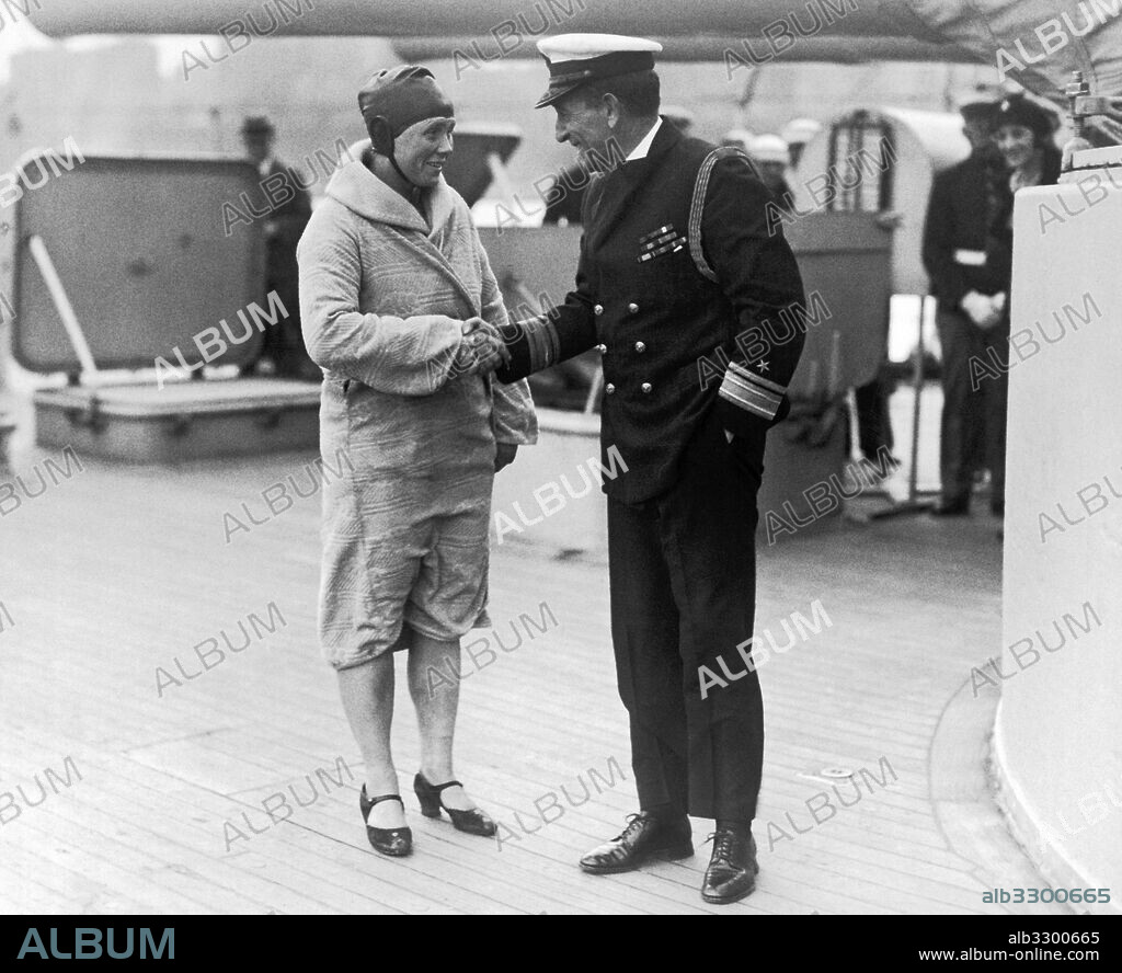 New York, New York: May 2, 1927.Mrs. Clemington Corson, (formerly Amelia "Millie" Gade) being congratulated by U.S. Navy Rear Admiral Yates Sterling, Chief of Staff on the Flagship Seattle. She was the first mother to swim the English Channel and was in New York giving an aquaplane demonstration to the sailors on the battleships anchored in the Hudson River.