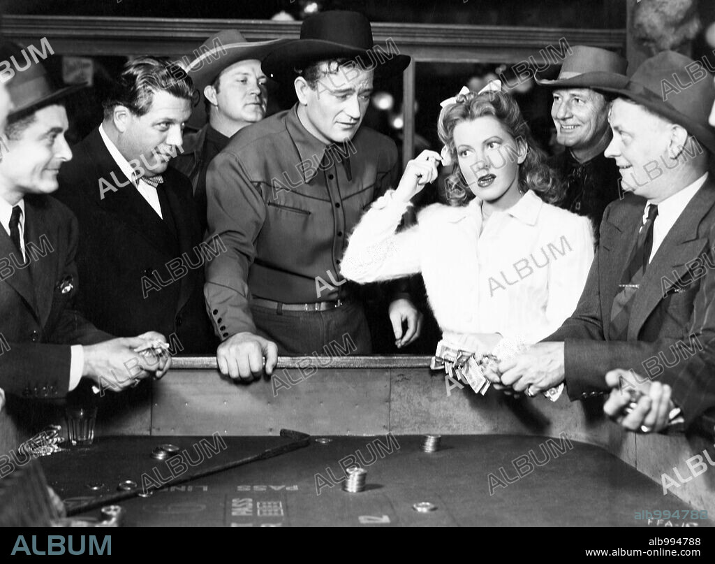 JEAN ARTHUR and JOHN WAYNE in A LADY TAKES A CHANCE, 1943, directed by WILLIAM A. SEITER. Copyright RKO.