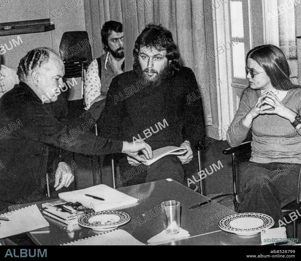 NORRKÖPING CA 1975-02-07. Internen Clark Olofsson med flickvännen Maria Wallin i samtal med Torsten Sjöholm under ett besök på Östgötateatern i Norrköping under en permission från fängelset, troligen 7:e februari 1975. I bakgrunden skymtas fångvaktaren. Olofsson är rådgivare på teatern inför uppsättningen av Brita Langs debattpjäs "Kung David" som spelas i April-maj.. Foto: Inge Hallberg / EXP / TT / Kod: 215. **AFTONBLADET OUT**.