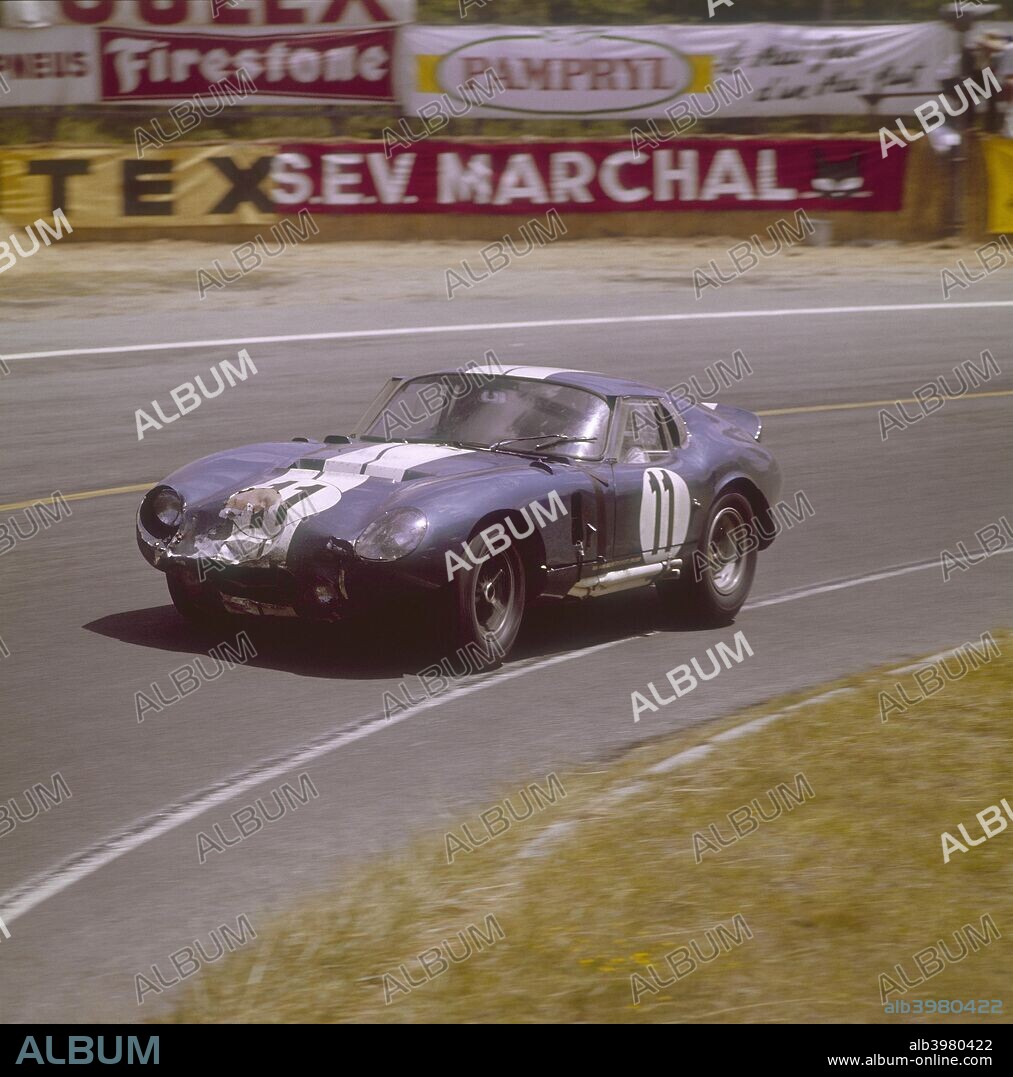A Cobra Daytona Ford, Le Mans, France, 1965. Racing round a bend. The front of the car has taken a knock. Driven either by Jack Sears or Richard Thompson. They won the GT 4001-5000cc class.