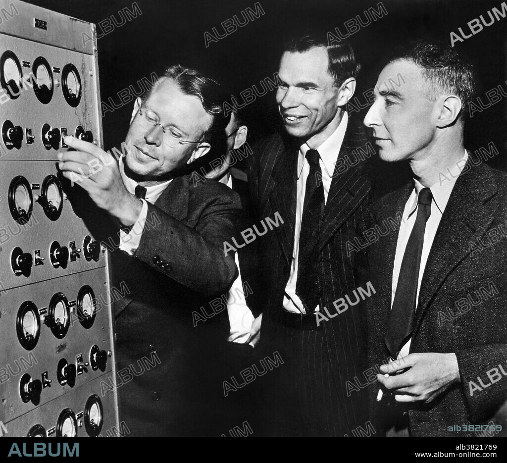 Lawrence, Seaborg and Oppenheimer in early 1946 at the controls to the magnet of the 184 inch cyclotron, which was being converted from its wartime use to its original purpose as a cyclotron. Ernest Orlando Lawrence (August 8, 1901 - August 27, 1958) was an American physicist and Nobel Laureate, known for his invention, utilization, and improvement of the cyclotron atom-smasher beginning in 1929, based on his studies of the works of Rolf Wideroe, and his later work in uranium-isotope separation for the Manhattan Project. Glenn Theodore Seaborg (April 19, 1912 - February 25, 1999) was an American chemist whose involvement in the synthesis, discovery and investigation of ten transuranium elements earned him a share of the 1951 Nobel Prize in Chemistry. Julius Robert Oppenheimer (April 22, 1904 - February 18, 1967) was an American theoretical physicist and professor of physics at the University of California, Berkeley. Along with Enrico Fermi, he is often called the "father of the atomic bomb" for his role in the Manhattan Project, the World War II project that developed the first nuclear weapons.