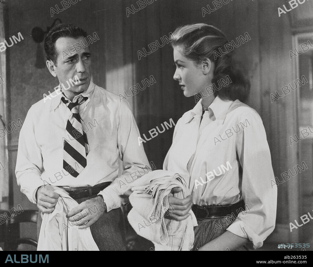HUMPHREY BOGART and LAUREN BACALL in KEY LARGO, 1948, directed by JOHN HUSTON. Copyright WARNER BROTHERS.