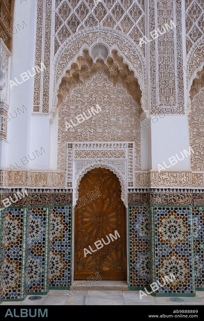 Morocco: A door in the corner of the central courtyard with zellij mosaic tilework either side and murqanas vaulted niche above, Ben Youssef Madrasa (Medersa Ben Youssef), Medina of Marrakesh, Marrakesh. The Saadian Dynasty sultan, Abdallah al-Ghalib Billah (1517 - 1574), built the madrasa in 1565 (972 AH). It was once the largest Islamic college in the Maghreb (Northwest Africa).