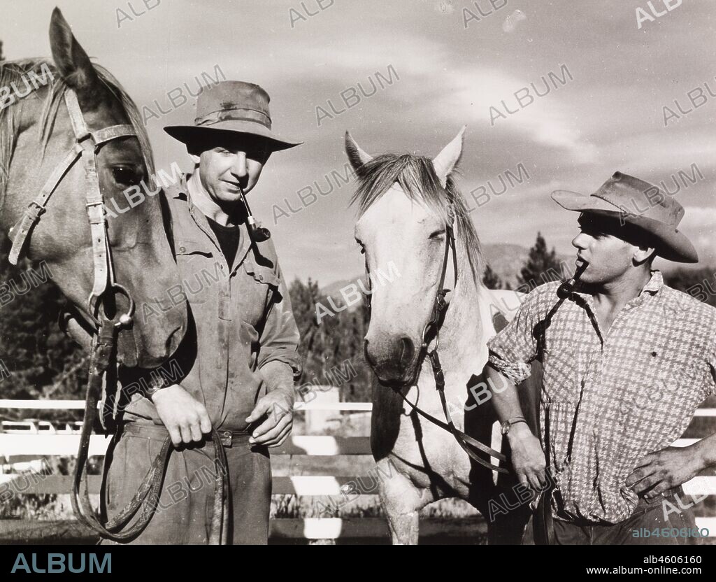 New Zealand, Station Owner and the Station Foreman, Glenrock Station, Rakaia Valley, South IslandCharles Ensor, station owner and the station foreman, stand with their horses, smoking pipes.Caption reads CHARLES ENSOR AND THE STATION FOREMAN, 1966. 2005/010/1/16/47.