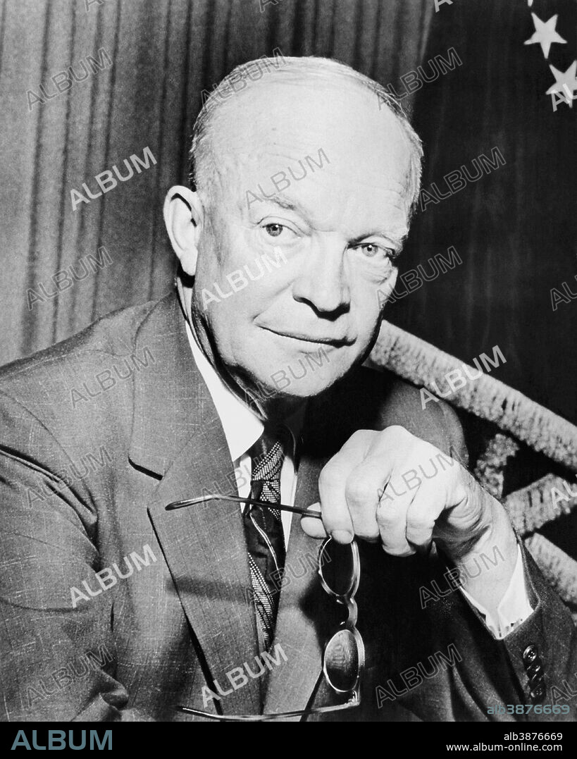 Digitally restored vintage American history photo of President Dwight Eisenhower holding a pair of glasses.