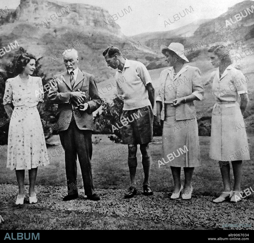 Photograph of King George VI with his wife and two daughters, Princess Margaret (right) and Princess Elizabeth (left) and Jan Smuts in South Africa. George VI (1895-1952) King of the United Kingdom and the Dominions of the British Commonwealth, the last Emperor of India and the first Head of the Commonwealth. Queen Elizabeth The Queen Mother (1900-2002). Princess Margaret, Countess of Snowdon (1930-2002). Princess Elizabeth (1926-) Queen of the United Kingdom, Canada, Australia and New Zealand. Field Marshall Jan Christiaan Smuts (1870-1950) a prominent South African and British Commonwealth statesman, military leader and philosopher. Dated 20th Century.