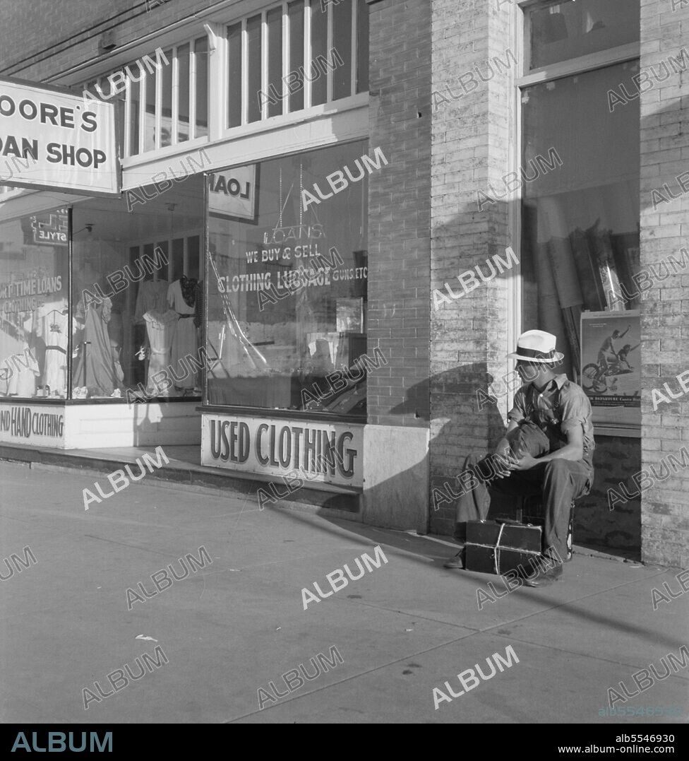 DOROTHEA LANGE. Main street storefront, Chickasaw, Oklahoma. This is a region from which hundreds of farm families have fled to the west. ['Loans - We Buy & Sell Clothing Luggage Guns etc - Used Clothing'].