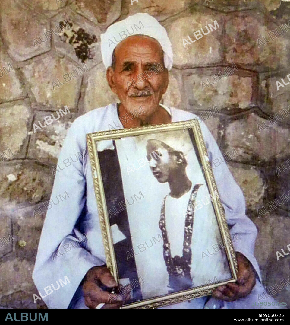 Husain Abdel Rassoul in 1992, holding his child portrait. Hussein Abdel Rassoul, 82. holds a photo of? himself taken 70 years before showing him wearing a pendant worn by King Tutankhamen. Abdel- Rasoul's father and Howard Carter discovered Tutankhamen's tomb in 1922. Husain Abdel Rassoul was 12 years of age when he attended the discovery of the tomb designated as KV 62.