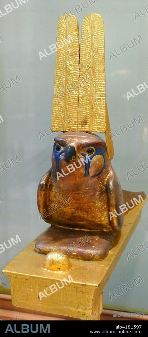 statuette depicting Sopdu a god of the sky. found in the tomb of King Tutankhamen. Sopdu was depicted as a falcon sitting on a religious standard. often with a two-feathered crown on his head and a flail over his shoulder.