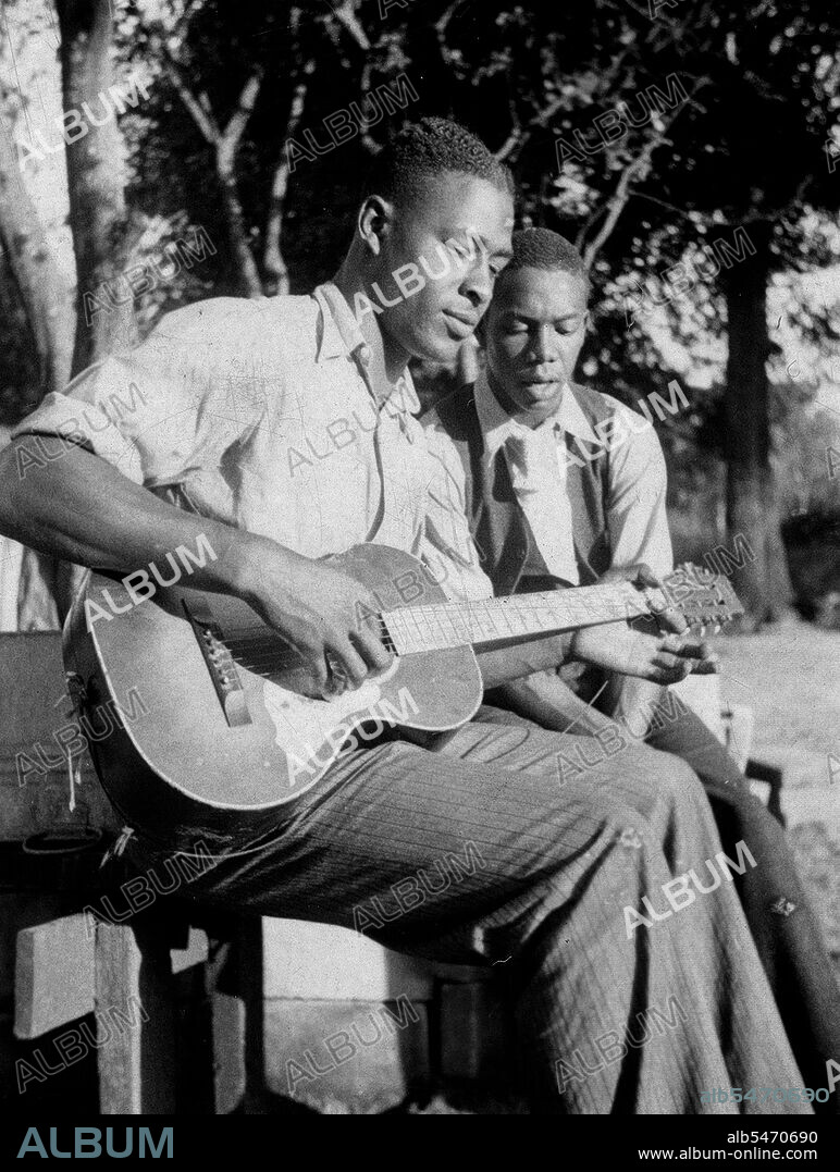 African American men playing guitar and singing; Gabriel Brown and Rochelle French, Eatonville, Florida circa June 1935.